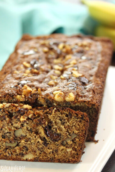 A loaf of banan bread with one slice cut off.