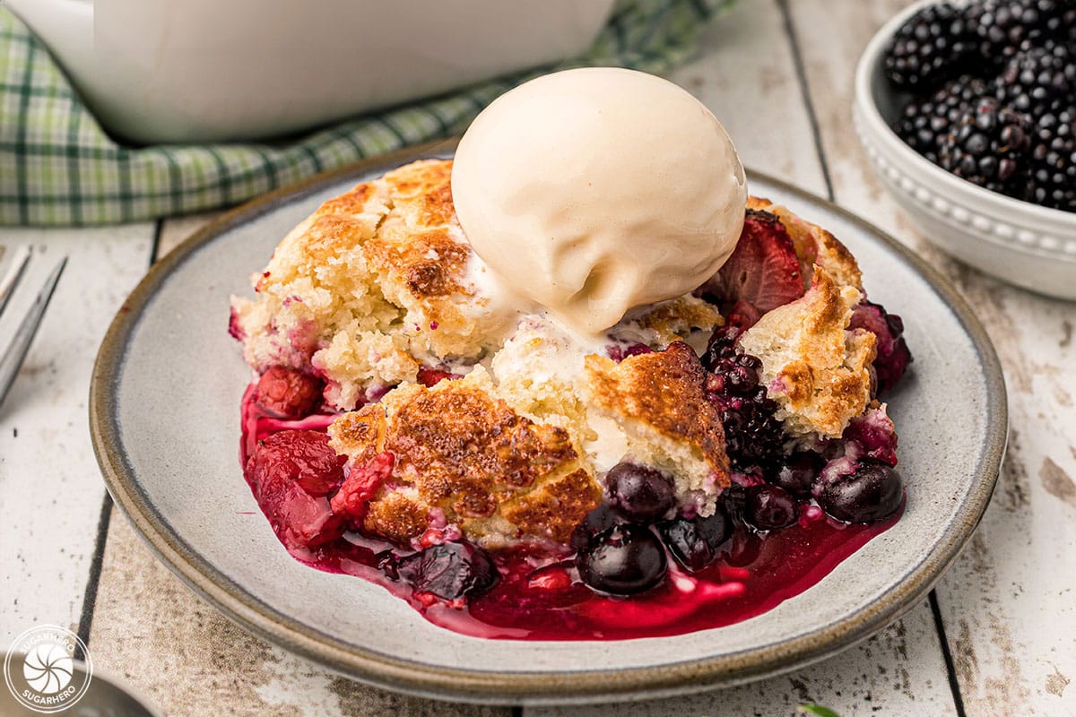 Close-up of Mixed Berry Cobbler with a scoop of vanilla ice cream