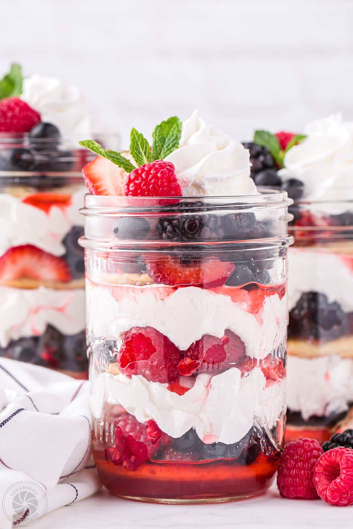 Close-up of Mixed Berry Shortcake in a mason jar with a mint sprig on top