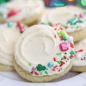 Close up of a big soft sugar cookie with four other big soft sugar cookies in the background.