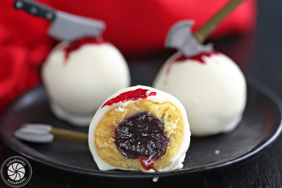 Close-up of a Bloody Halloween Cake Ball, cut in half to show the cherry inside.