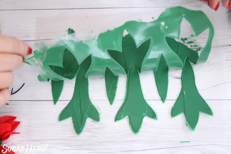 Blooming Chocolate Flowers - peeling back a template to create green chocolate leavese | From SugarHero.com