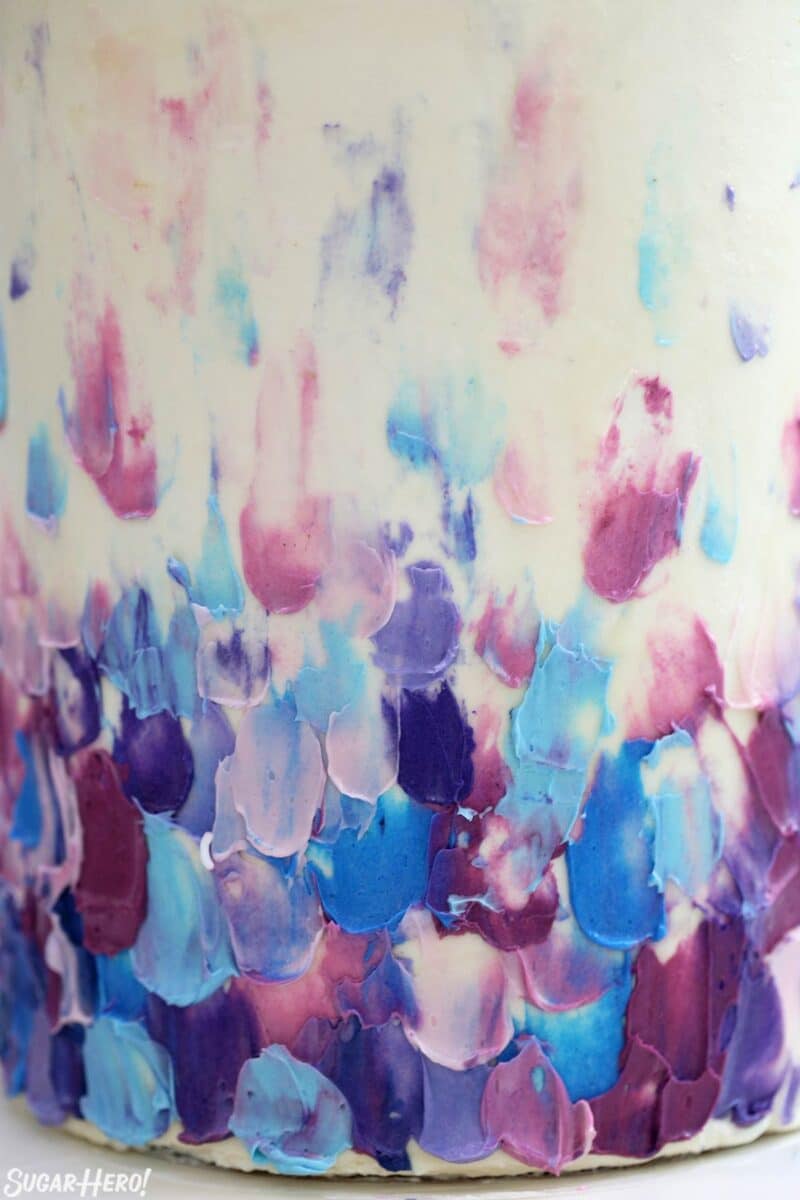Close-up of the blue and purple frosting decorations on the side of the Blueberry Layer Cake.