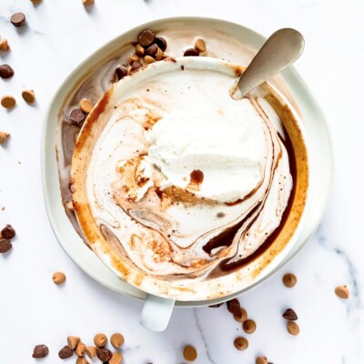 Overhead view of Boozy Peanut Butter Hot Chocolate surrounded with sprinkled mini peanut butter and chocolate chips.