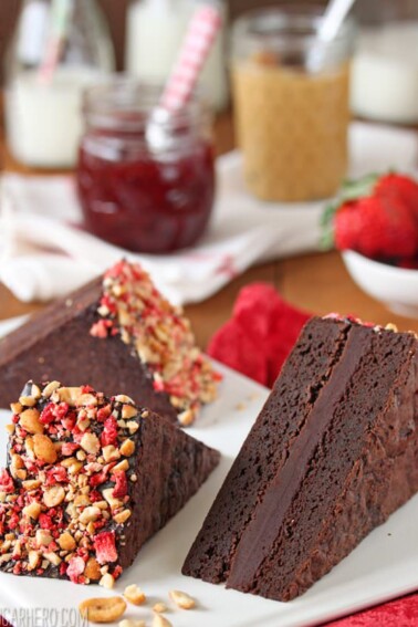 3 Peanut Butter and Jelly Brownie Sandwiches on a white plate.