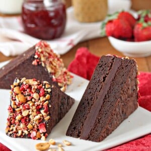 3 Peanut Butter and Jelly Brownie Sandwiches on a white plate.