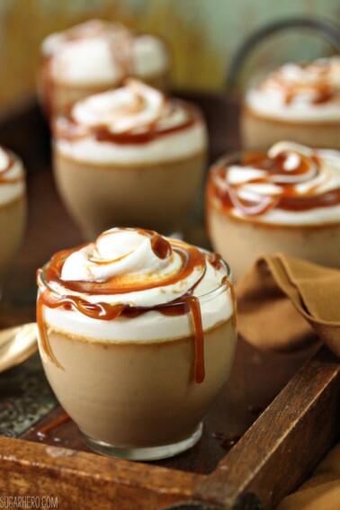 Close view of several Butterscotch Pots de Creme on a wooden serving tray.