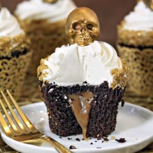 Close up of a Caramel-Stuffed Chocolate Cupcake with bite removed to show interior.