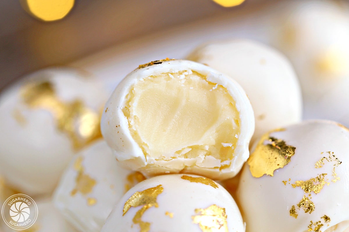Close-up of Champagne White Chocolate Truffles with a bite taken from one of them