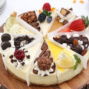 Cheesecake sampler with 10 different flavors on a wooden platter.
