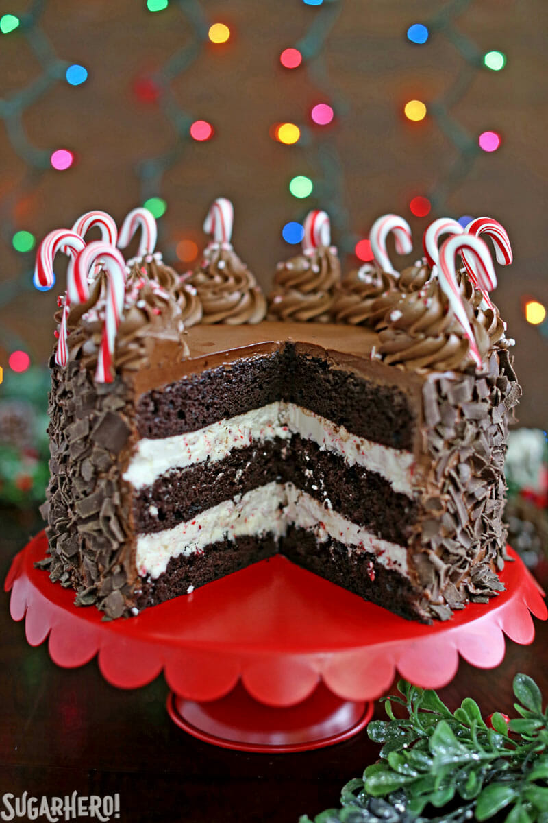 Chocolate Candy Cane Cake &ndash; the cake cut open on a red cake stand | From SugarHero.com