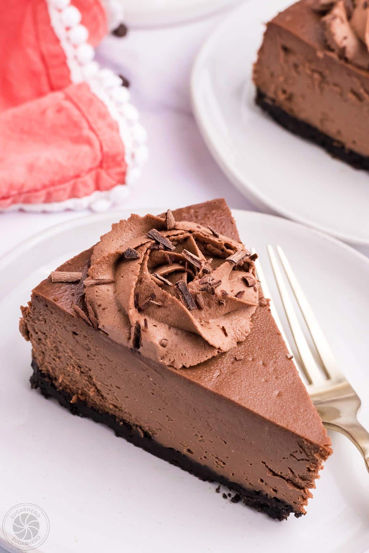 A slice of Chocolate Cheesecake on a white plate.