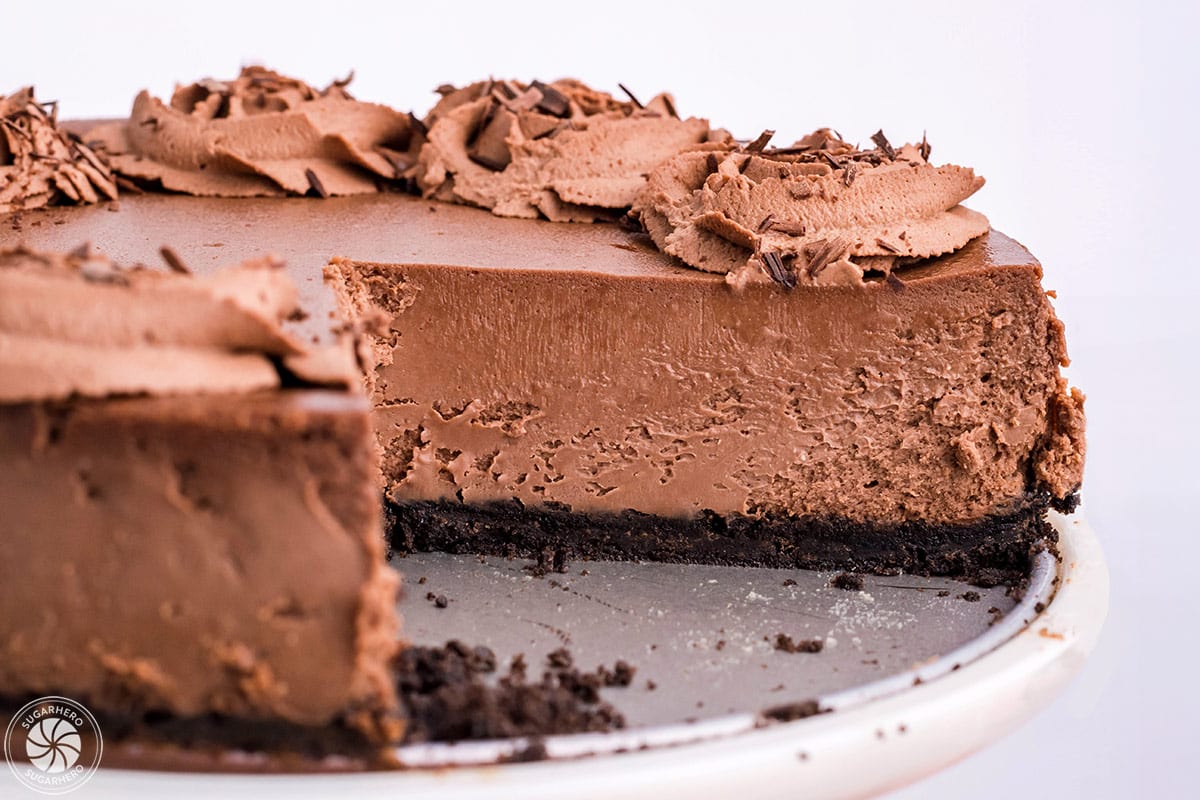 Close up of a Chocolate Cheesecake with a slice removed to show internal texture.