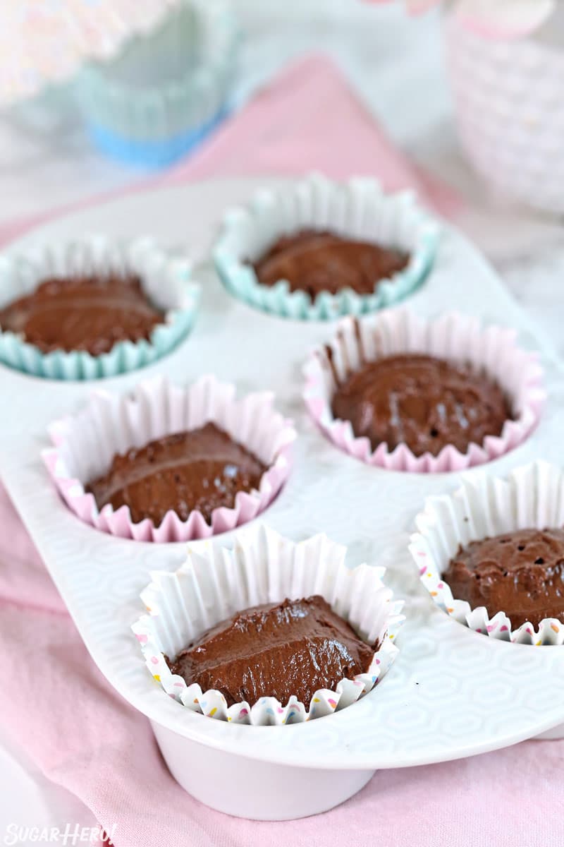 Cupcake pan filled with chocolate cupcake batter, before baking