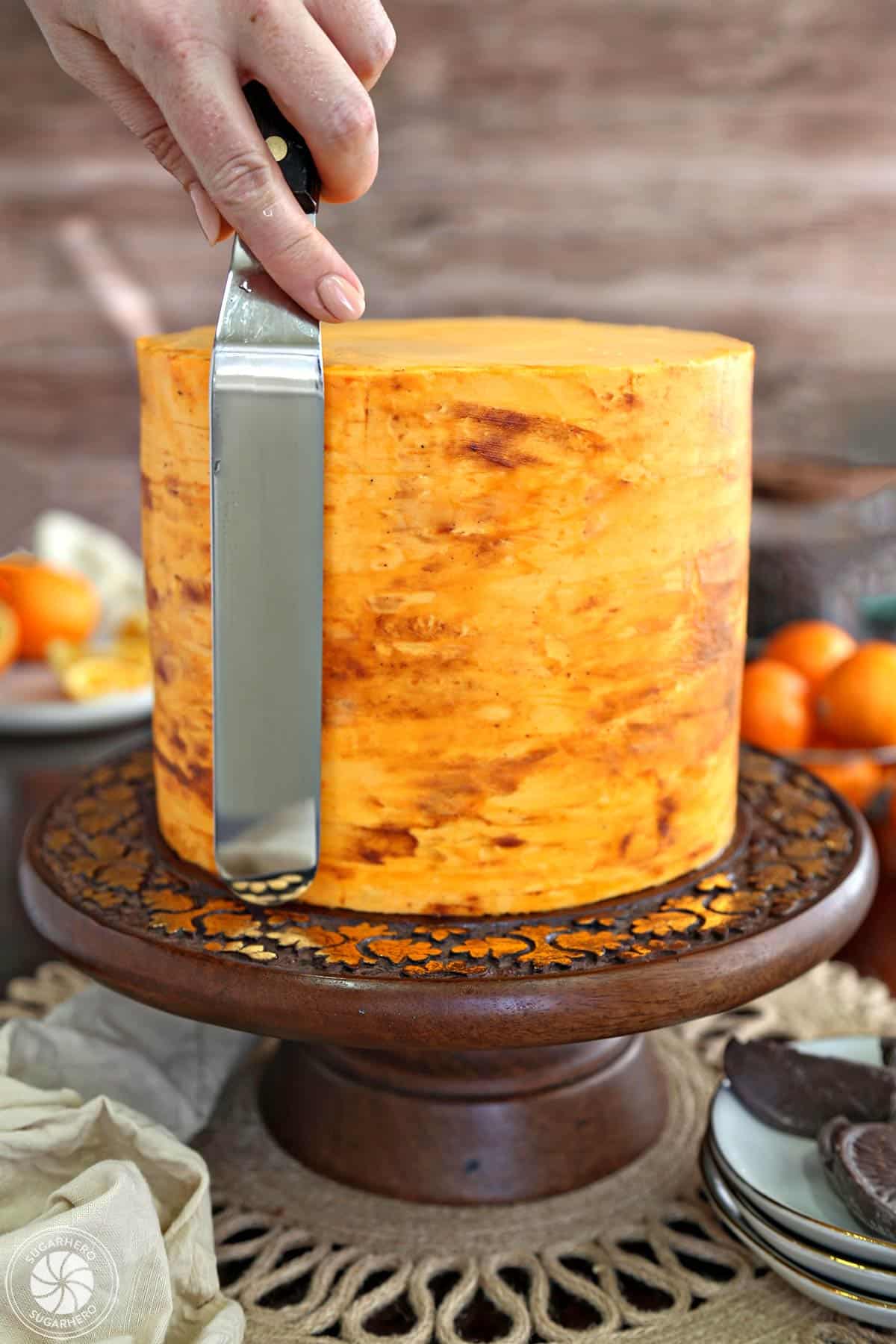 Blending the chocolate frosting into the orange frosting on the cake.