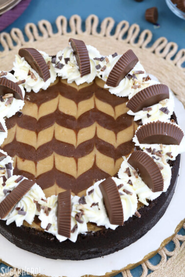 Overhead shot of Chocolate Peanut Butter Cheesecake on a white and blue surface.