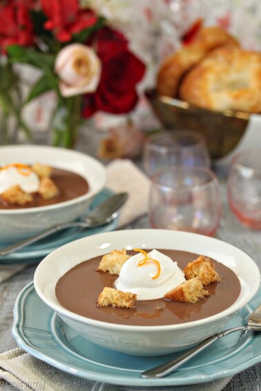 Close up of a bowl of Chocolate Soup with croissant croutons and a large dollop of creme fraiche.