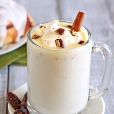 Cup of Cinnamon Bun White Hot Chocolate on a small white plate.