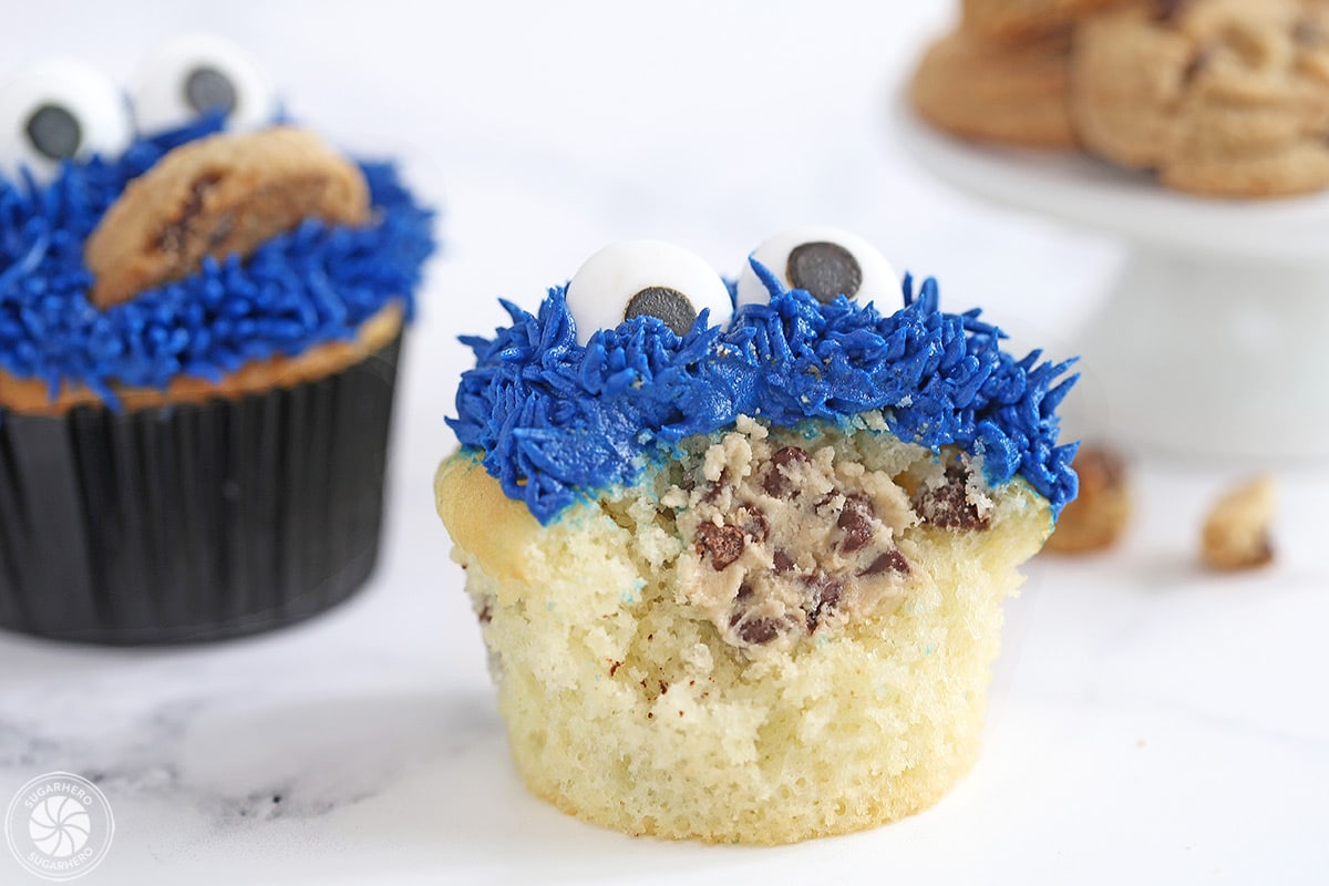 Cookie Monster Cupcake with a bite taken out of it, showing the cookie dough filling inside.