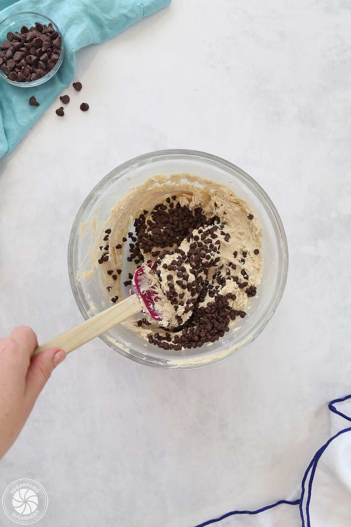 Frosting with chocolate chips being mixed into it.