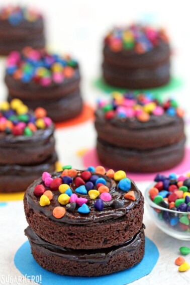Close up of a Cosmic Brownie Mini Cake next to a bowl of rainbow chips.
