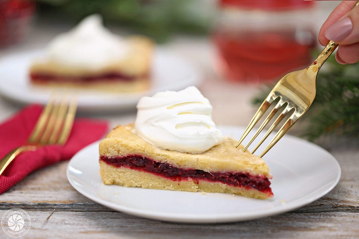 Slice of Cranberry Sauce Cake with a gold fork about to take a bite out of it.