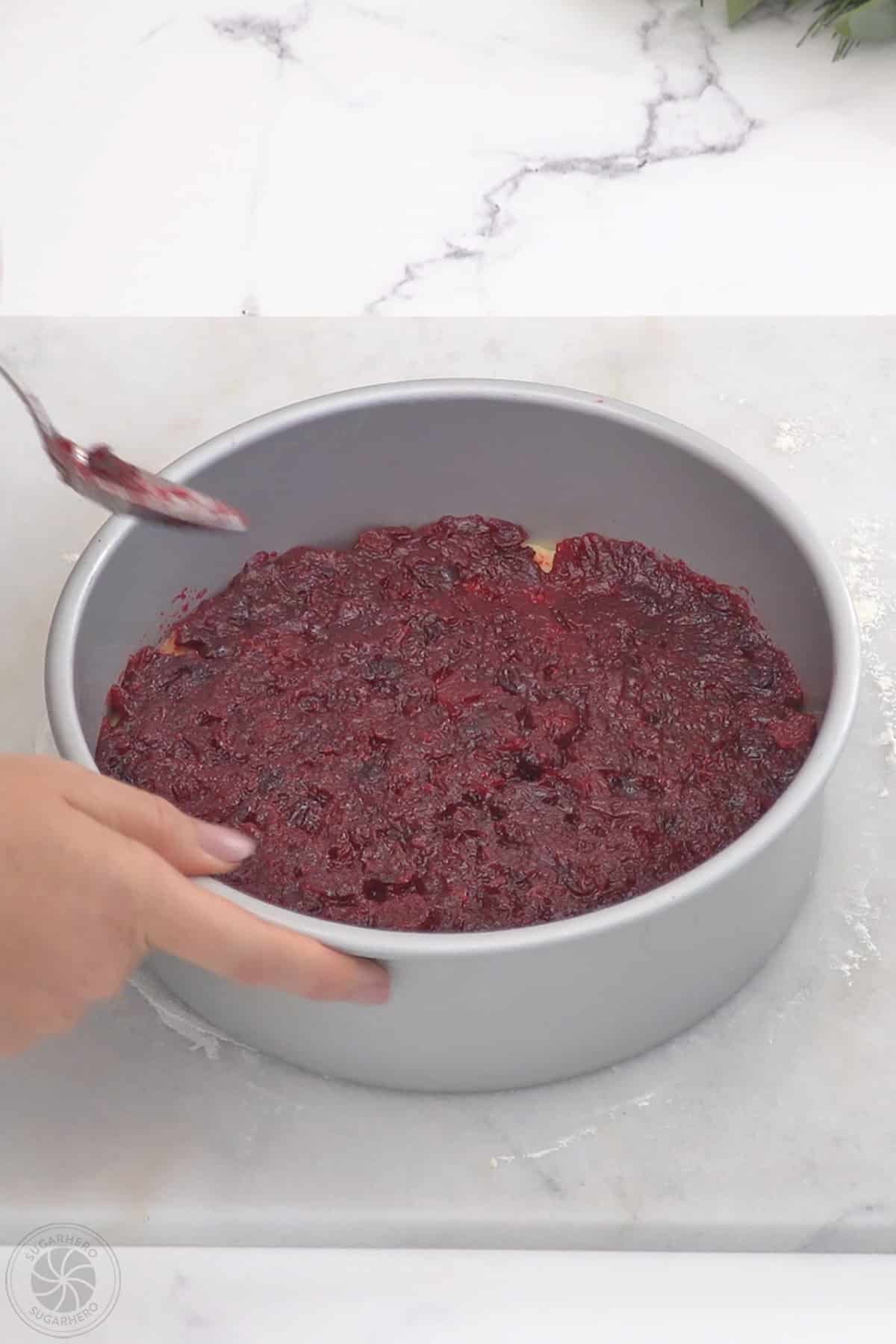 Cranberry sauce filling spread over the top of the bottom cake layer.