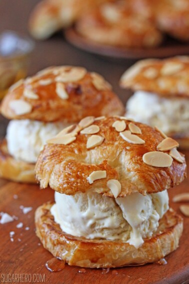 3 Croissant Salted Honey Ice Cream Sandwiches on a wooden surface.