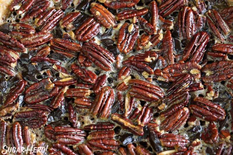 Deep Dish Pecan Pie - close-up of the pecans and chocolate chunks on top of the pie | From SugarHero.com