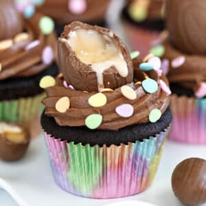 A Chocolate Cr&egrave;me Egg Cupcake in a rainbow wrapper.