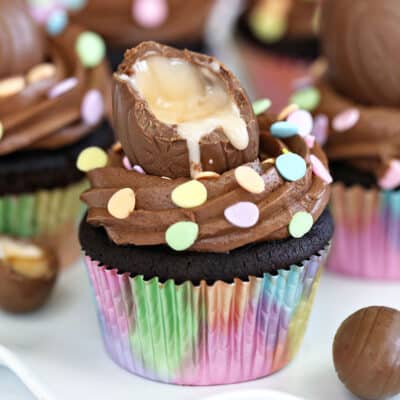 A Chocolate Cr&egrave;me Egg Cupcake in a rainbow wrapper.
