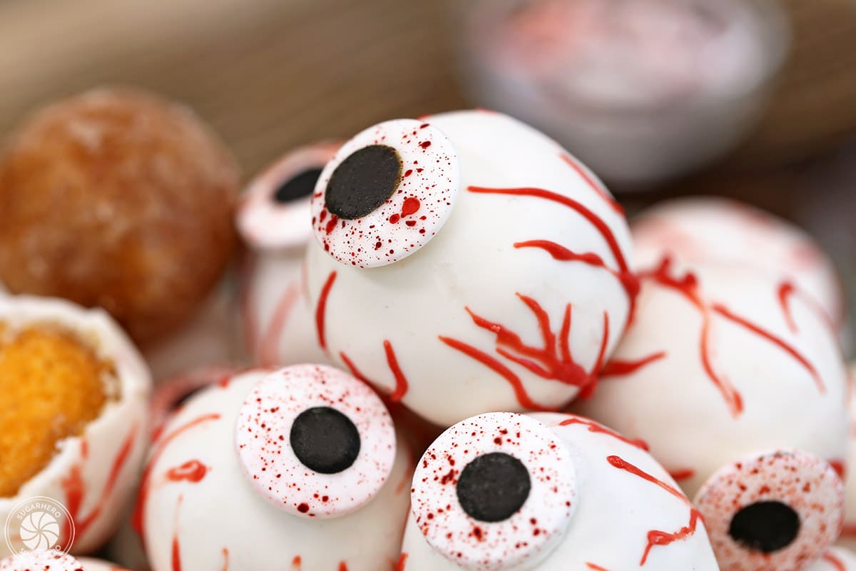 Close-up of Donut Hole Eyeballs with plain donut hole in the background.