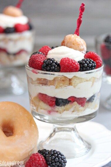 Close up of a Doughnut Trifle next to a large glazed doughnut.