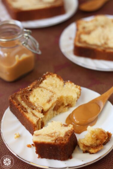 A broken slice of Dulce de Leche Swirl Pound Cake next to a spoonful of dulce de leche.