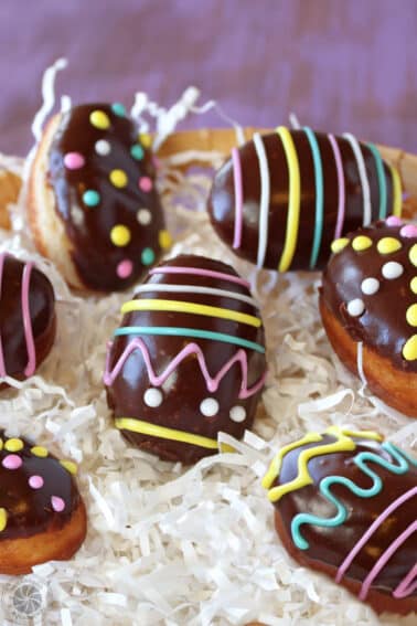 Easter Egg Doughnuts on white paper shreds.