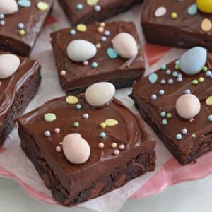 Easter Egg Brownies on a white plate with Cadbury mini eggs on top and next to it.