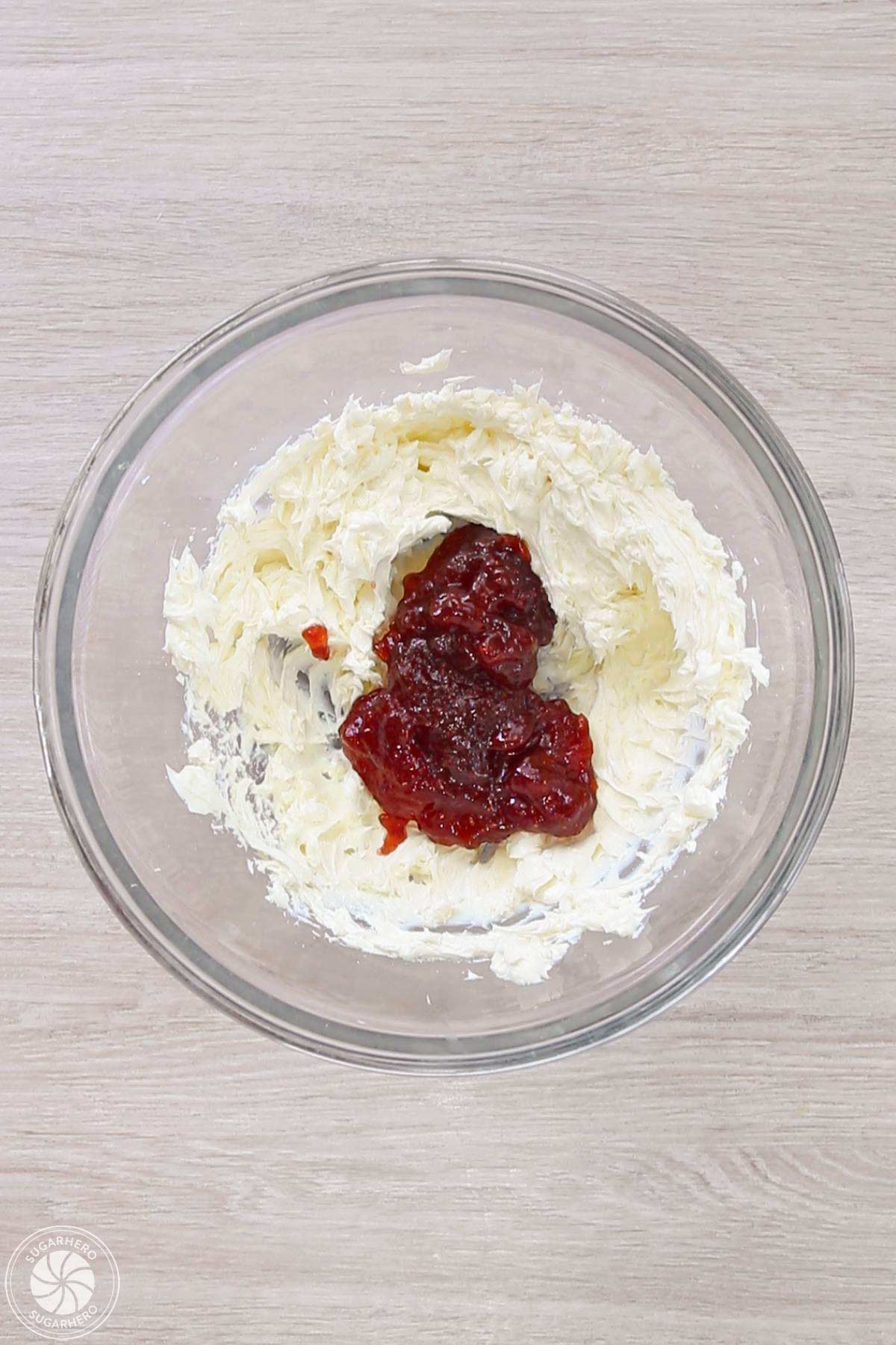 Cream cheese with a dollop of strawberry jam to make fruit pizza topping.