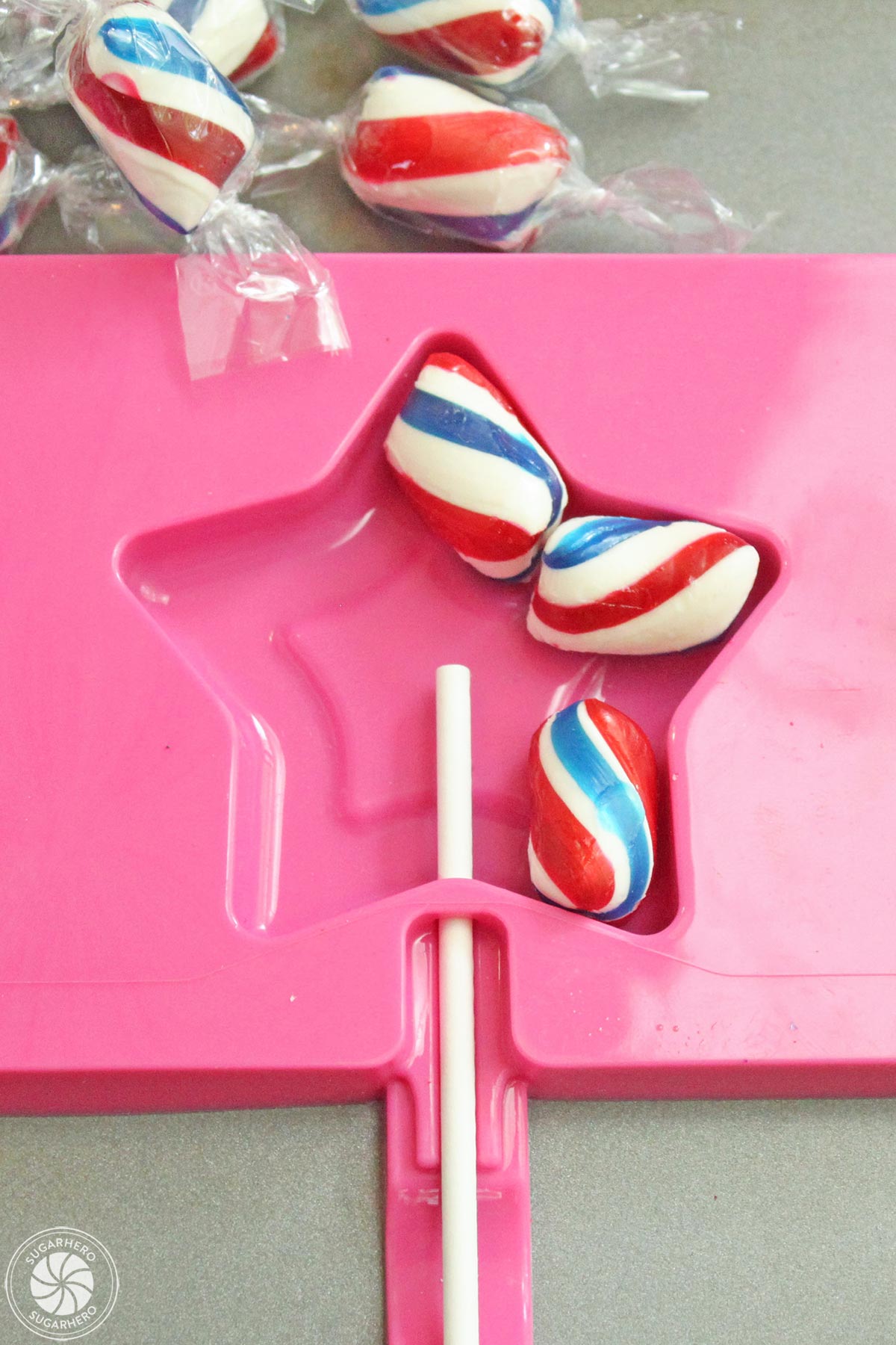 Hard candy placed inside of star silicone lollipop mold.