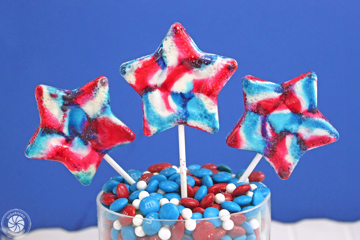 Close up of three red, white and blue star lollipops.
