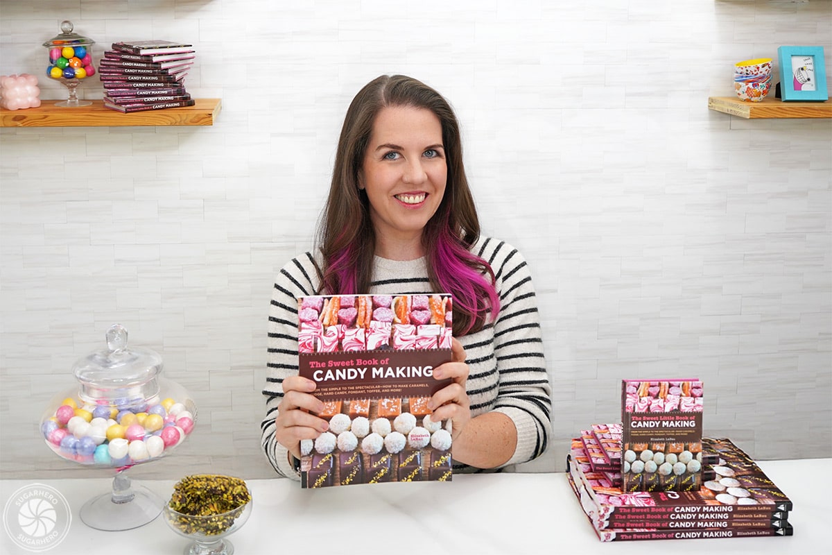 Elizabeth LaBau holding a copy of The Sweet Book of Candy Making.