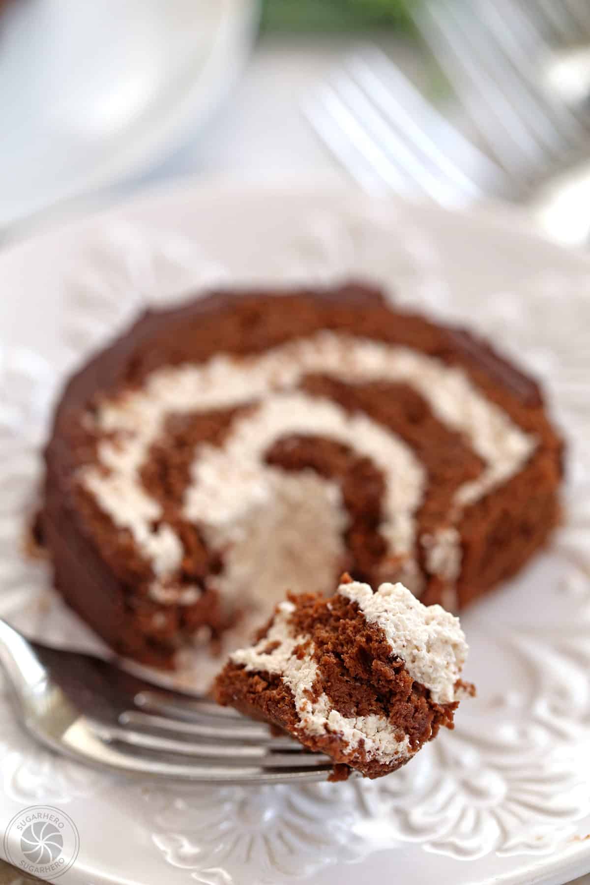 A bite of a slice of Flourless Chocolate Buche de Noel on a fork.
