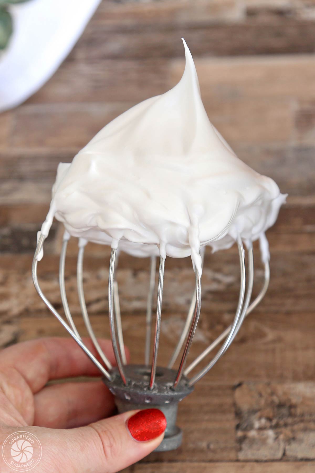Whipped egg white mixture on a whisk attachment.