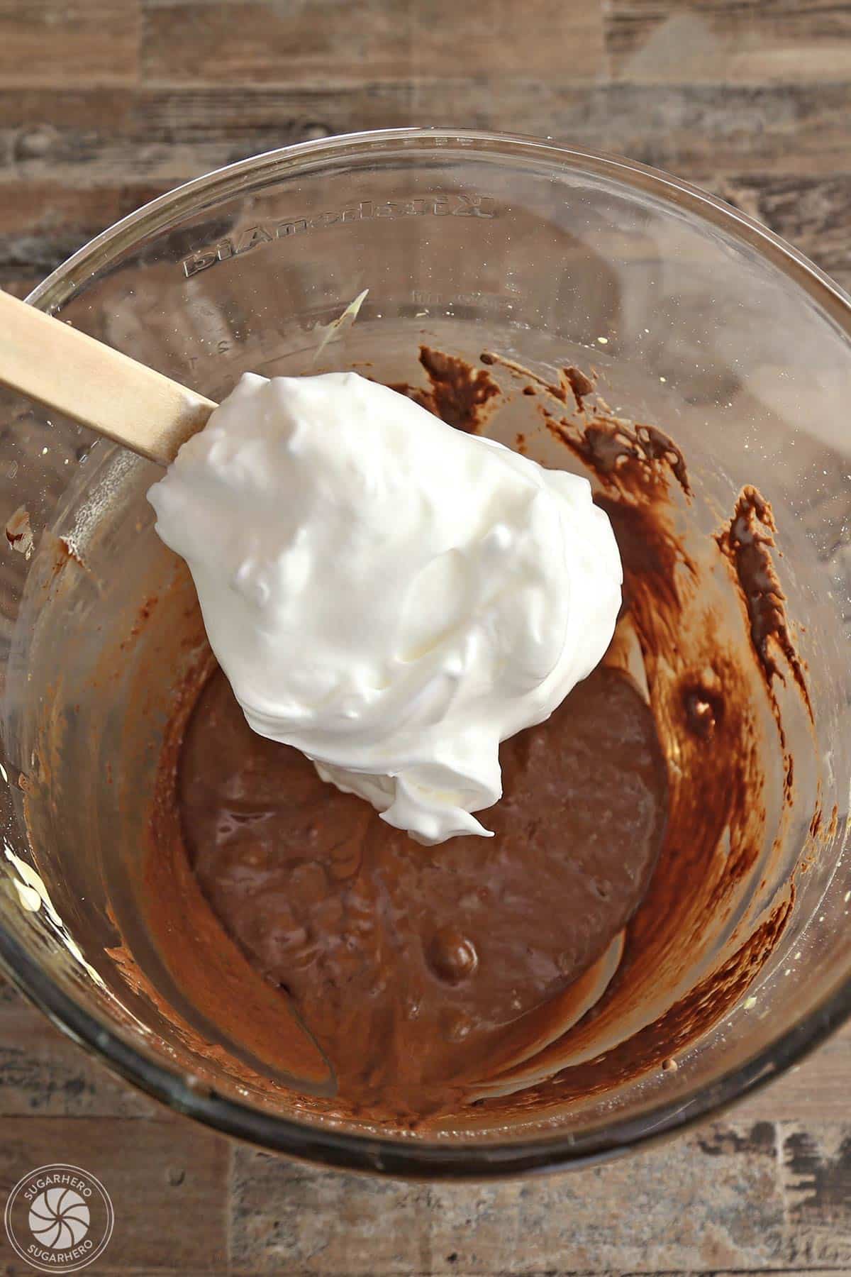 Adding some egg white mixture into the chocolate egg yolk mixture.