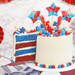 Hand removing a slice of Fourth of July Layer Cake.