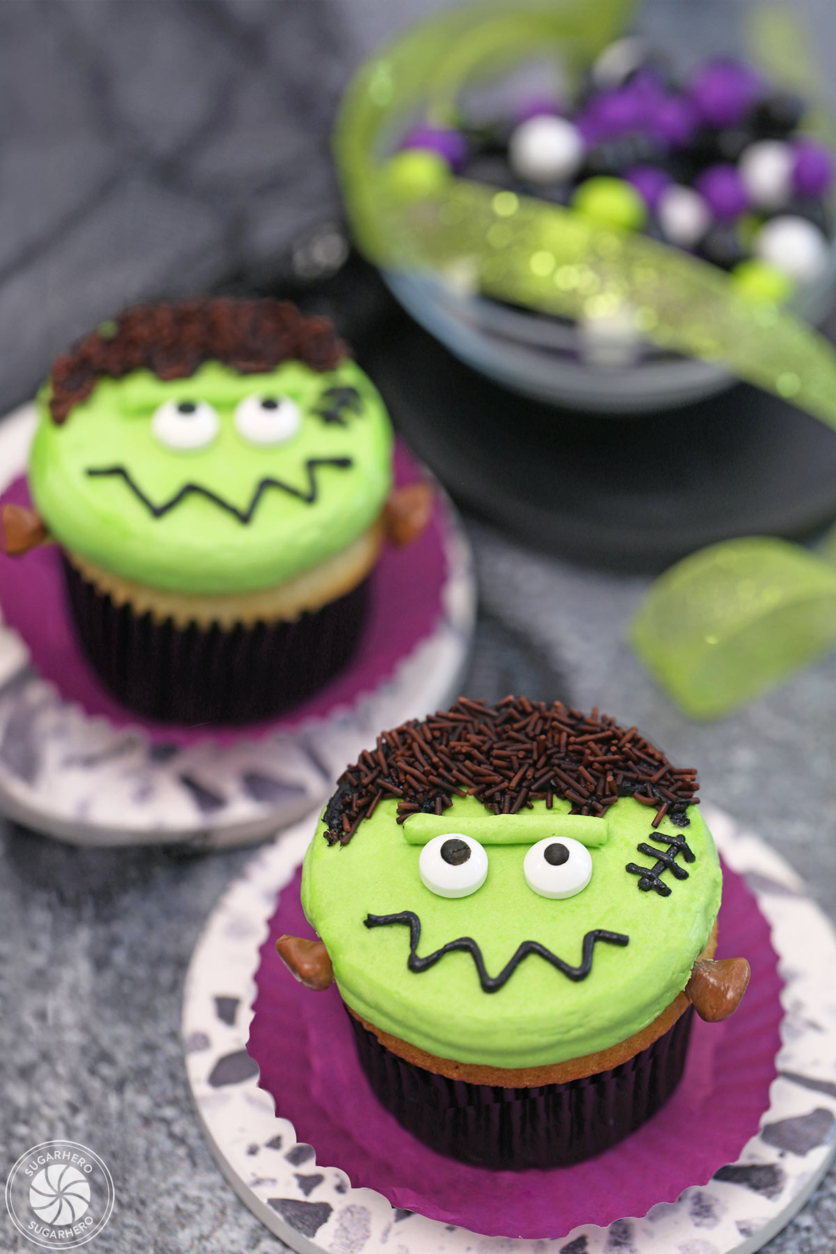 2 Frankenstein Cupcakes on purple wrappers.