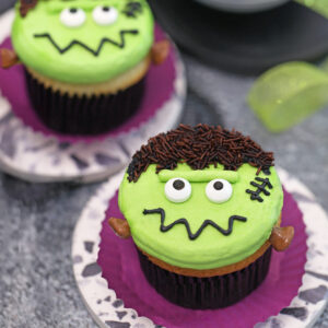 Close up of a Frankenstein Cupcake on a purple wrapper.