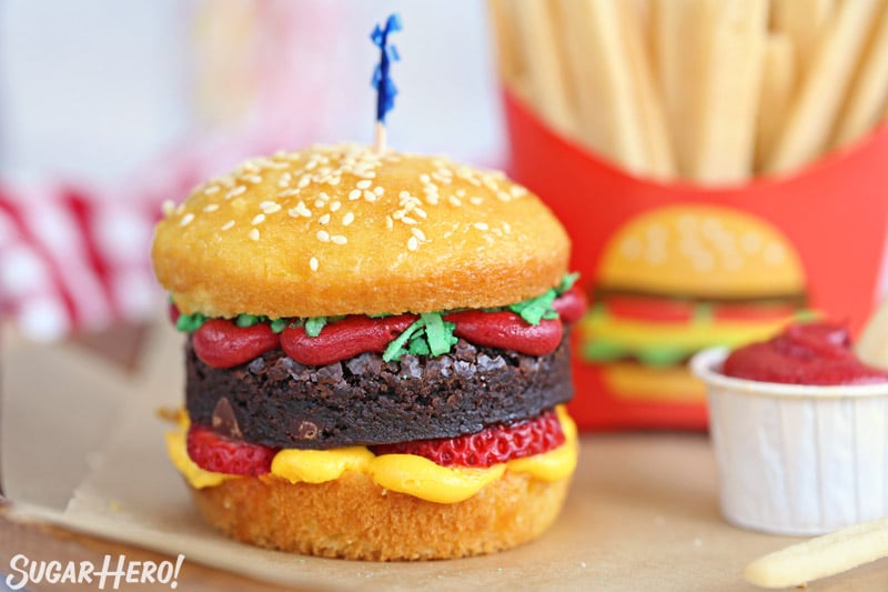 Hamburger cupcake with sesame seeds on top, and sugar cookie french fries in the background