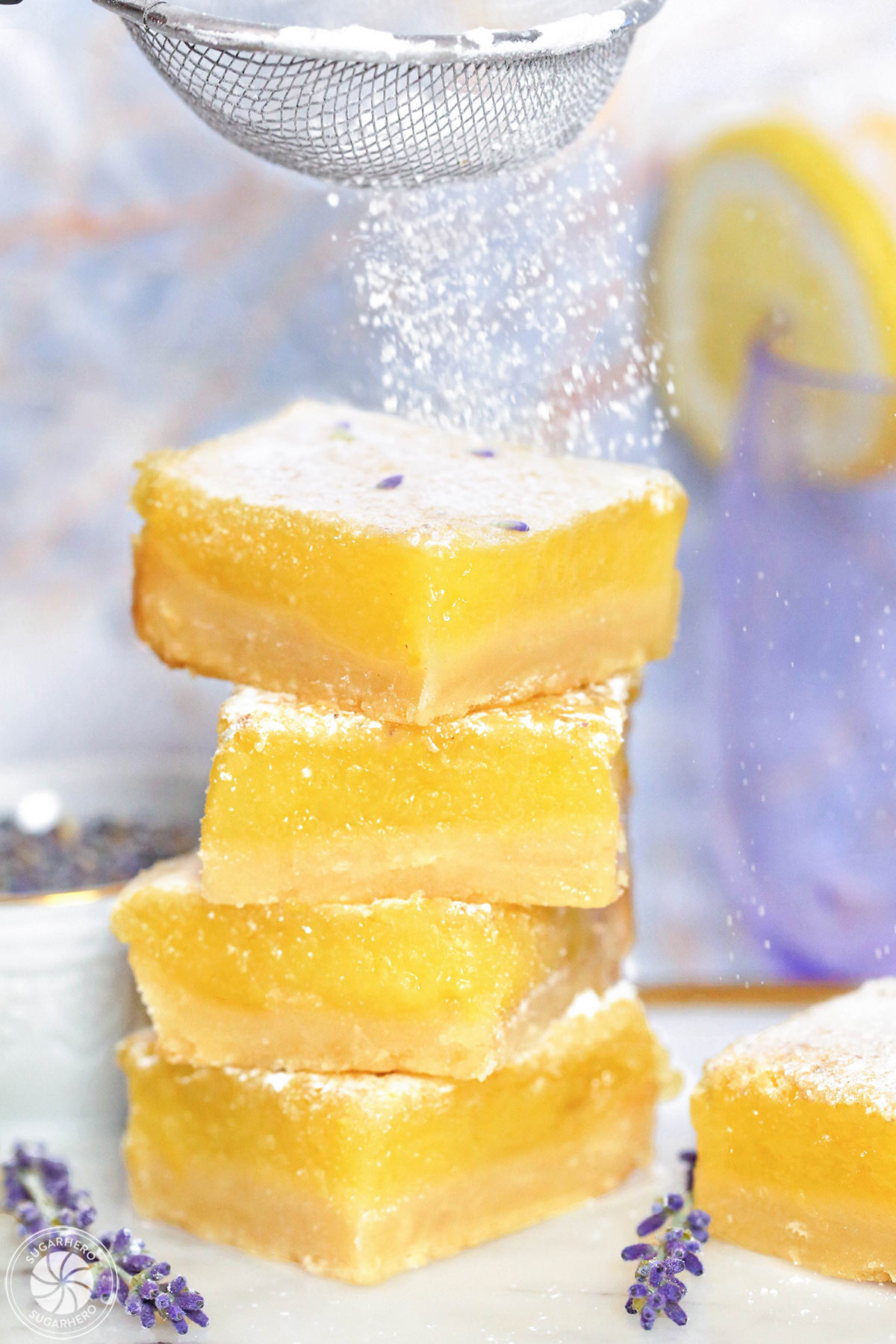 Lavender Lemon Bars - bowl of lavender sugar with lavender buds on top | From SugarHero.com