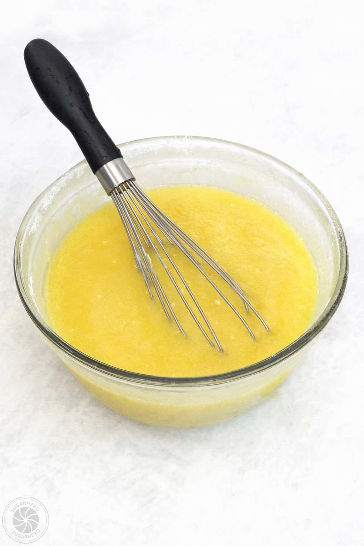 Lavender Lemon Bar filling in a mixing bowl with a whisk in it.