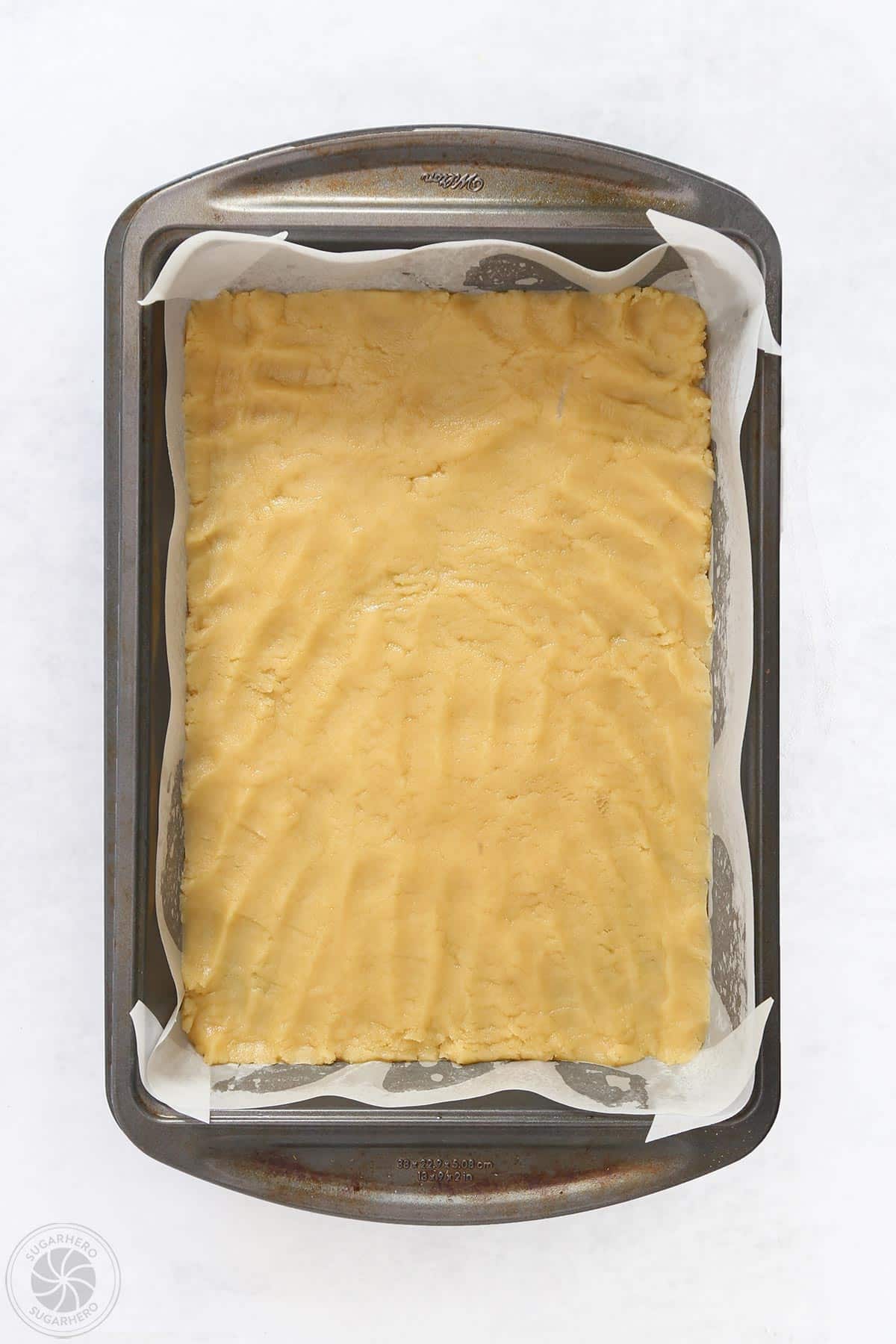 Shortbread crust pressed into a baking pan.